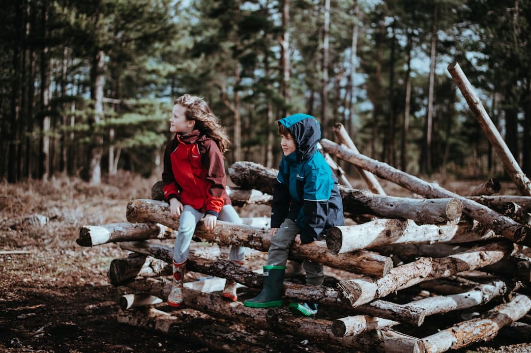 Kids sitting together in a Stanley Park forest clearing